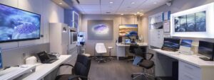 a sleek, modern clinic interior showcases a patient consultation in progress, with a knowledgeable dermatologist discussing prp therapy options for hair restoration, surrounded by detailed posters of scalp health and advanced medical equipment.